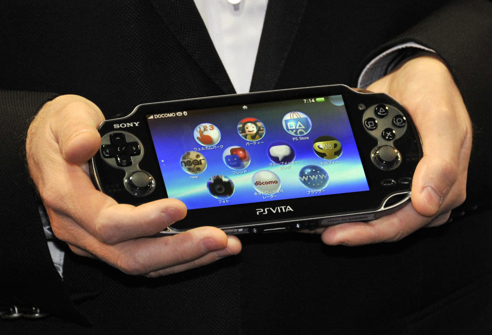 Japan's video game giant Sony Compuer Entertainment (SCE) president Andrew House displays the new portable video game console 