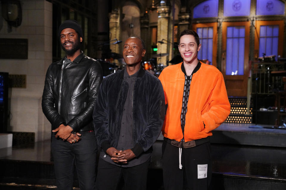 Saturday Night Live host Don Cheadle, flanked by musical guest Gary Clark Jr. (left) and Pete Davidson, used sports to throw shade at president Donald Trump on the live broadcast. (Getty)