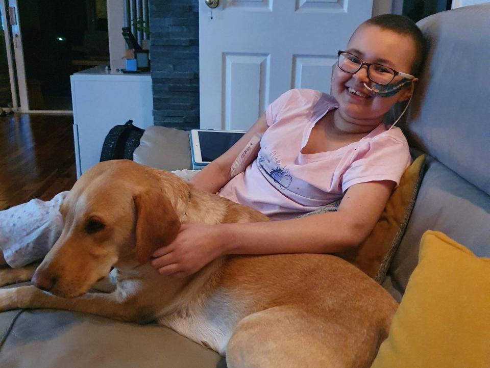 Alyssa relaxing at home with her dog