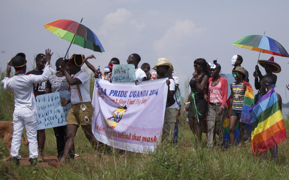 Ugandans take part in the 3rd Annual Lesbian, Gay, Bisexual and Transgender (LGBT) Pride celebrations in Entebbe, Uganda, Saturday, Aug. 9, 2014.  Scores of Ugandan homosexuals and their supporters are holding a gay pride parade on a beach in the lakeside town of Entebbe. The parade is their first public event since a Ugandan court invalidated an anti-gay law that was widely condemned by some Western governments and rights watchdogs.(AP Photo/Rebecca Vassie)