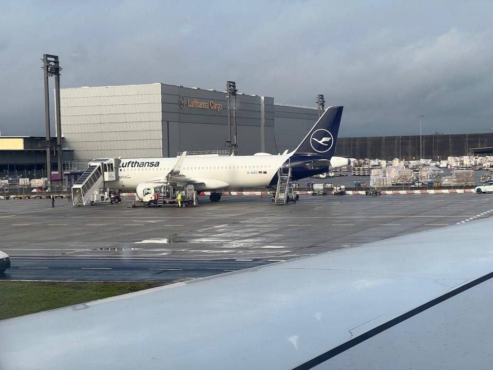 A view out the window with a Lufthansa plane in the background.