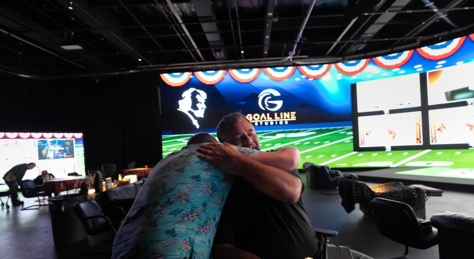 Joe Madden (right) says goodbye to Jack Madden after NFL play wrapped up Sunday.