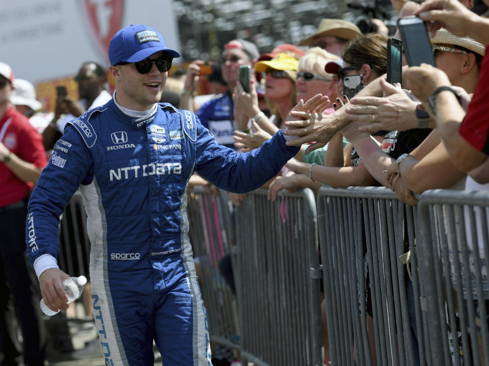FILE - In this Sunday, March 10, 2019, file photo, Chip Ganassi Racing's Felix Rosenqvist (10), of Sweden, greets fans before the IndyCar Firestone Grand Prix of St. Petersburg auto race in St. Petersburg, Fla. The 2020 season will open Saturday night, June 6, 2020, at Texas Motor Speedway. It will be radically different from the last time the series was together in St. Petersburg, Florida, soaking up the sun and enjoying the party atmosphere of the traditional season opener. (AP Photo/Jason Behnken, File)