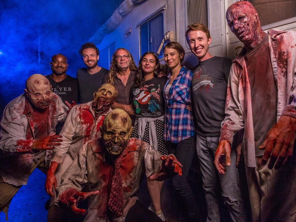 Cast members from AMC's "The Walking Dead" post with scareactors at the show's haunted house at Universal Studios Orlando in 2016.