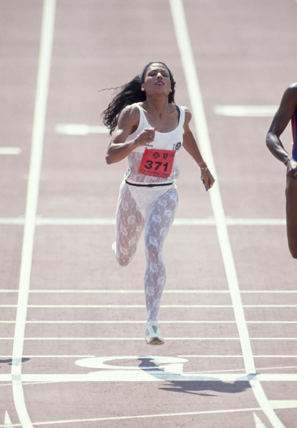 INDIANAPOLIS, IN - JULY 23:  Florence Griffith Joyner #371 of the USA competes in the final of the Women's 200 meter race of the 1988 USA Track and Field Olympic Trials held July 22, 1988 at the IU Michael A. Carroll Track & Soccer Stadium in Indianapolis, Indiana.  (Photo by David Madison/Getty Images)