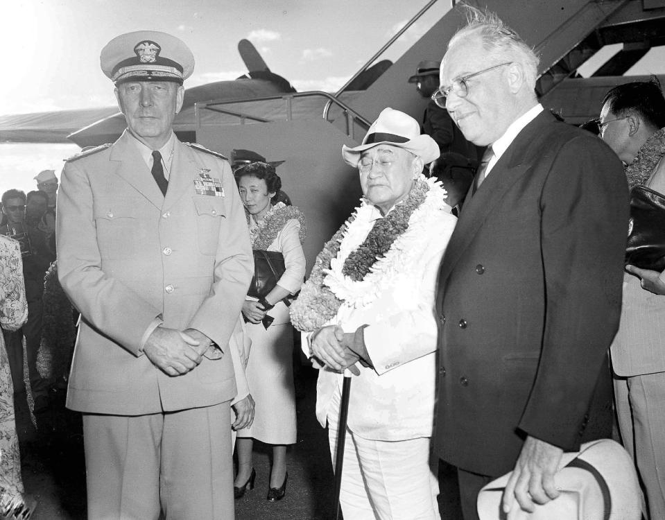 FILE - In this Aug. 31, 1951, file photo, Japanese Prime Minister Shigeru Yoshida, center right, accompanied by his daughter, Kazuko, center left, is greeted by Adm. Arthur Radford, left, commander of the U.S. Pacific Fleet, and Joseph R. Farrington, who serves as a delegate of the U.S. Congress for the Territory of Hawaii, during an arrival ceremony for Yoshida in Honolulu, Hawaii. Yoshida is best remembered for signing the San Francisco peace treaty with the U.S. and others in 1951, allowing Japan back into international society after its war defeat. His Pearl Harbor visit, which he made on his way home from San Francisco, was largely eclipsed by the historic treaty. (AP Photo/File)