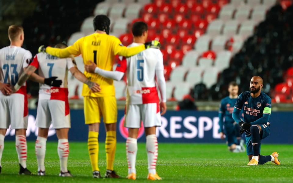 Arsenal captain Alexandre Lacazette (R) takes a knee to support anti racism ahead of the UEFA Europa League quarter final - Shutterstock