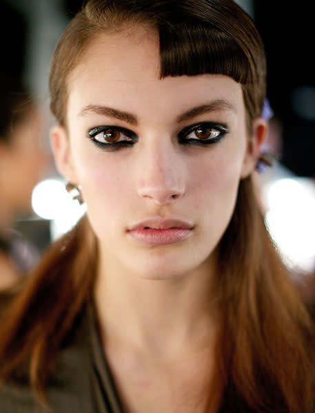<b>Michael van der Ham <br></b><br>The beauty look at the show consisted of black kohl rimmed eyes and retro style fringes.<br><br>Image © Getty