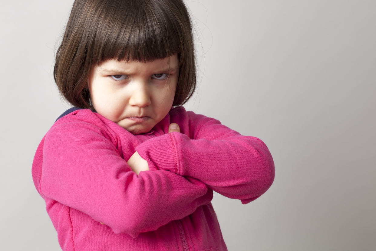 unhappy boyish 4-year old girl expressing disagreement with body language