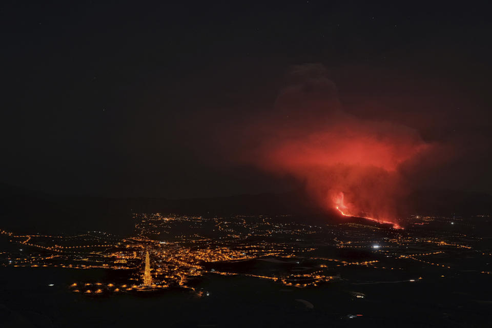 Lava spews from a volcano on the Canary island of La Palma, Spain in the early hours of Saturday Sept. 25, 2021. A volcano in Spain's Canary Islands is keeping nerves on edge several days since it erupted, producing loud explosions, a huge ash cloud and cracking open a new fissure that spewed out more fiery molten rock. The prompt evacuations are credited with helping avoid casualties but scientists say the lava flows could last for weeks or months. (AP Photo/Daniel Roca)