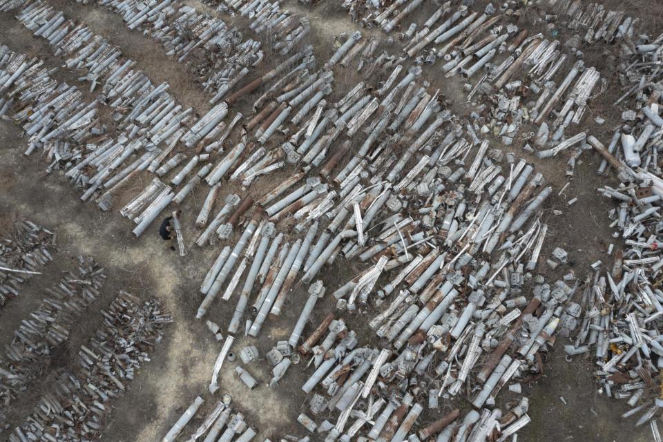 A prosecutor examines fragments of Russian missiles that were collected to investigate Russia's military crimes in Kharkiv, Ukraine, Monday, March 18, 2024. (AP Photo/Efrem Lukatsky)