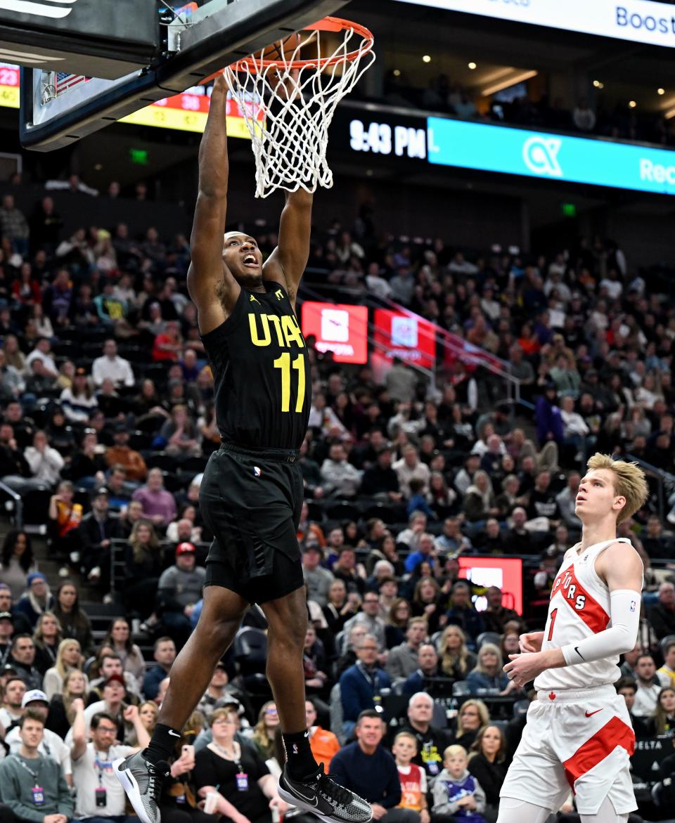 Utah Jazz guard <a class="link " href="https://sports.yahoo.com/nba/players/5636" data-i13n="sec:content-canvas;subsec:anchor_text;elm:context_link" data-ylk="slk:Kris Dunn;sec:content-canvas;subsec:anchor_text;elm:context_link;itc:0">Kris Dunn</a> (11) dunks the ball as Toronto Raptors guard Gradey Dick (1) trails behind as the Jazz and Raptors play at the Delta Center in Salt Lake City on Friday, Jan. 12, 2024. Utah won 145-113. | Scott G Winterton, Deseret News