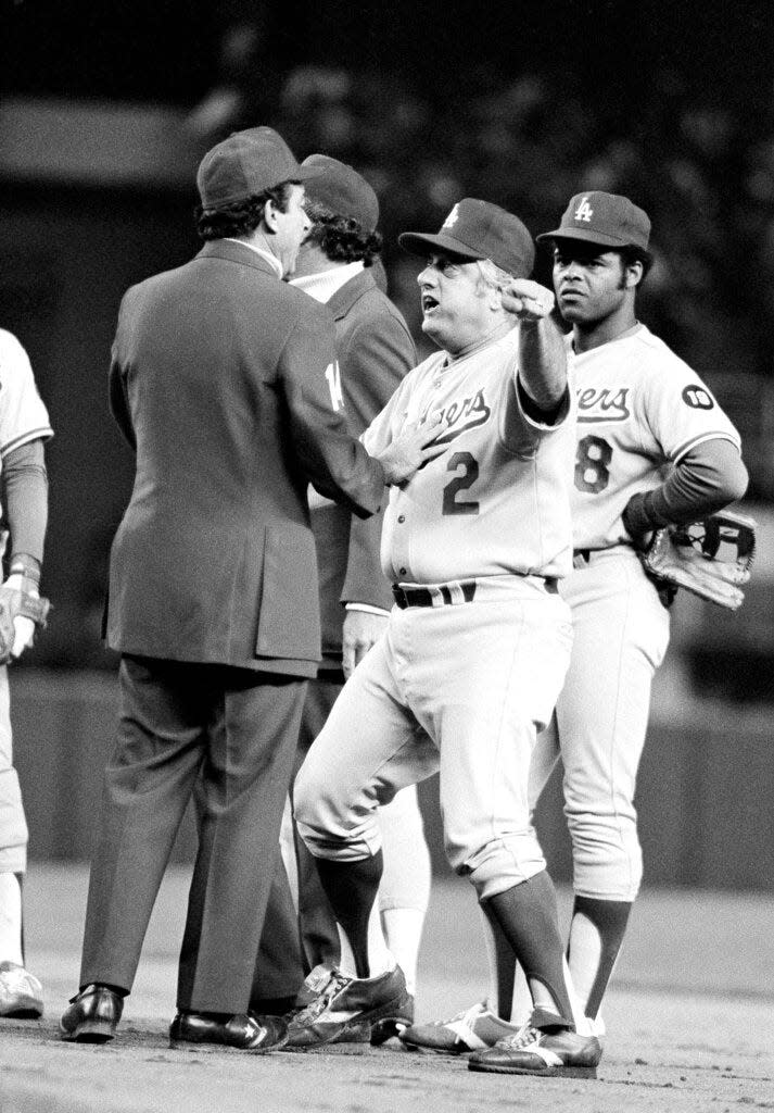 Los Angeles Dodgers manager Tom Lasorda argues with umpire Frank Pulli on a controversial play in seventh inning of a World Series game with Yankees in New York, Saturday, Oct. 14, 1978. Lasorda argued possible interference by Yanks' Reggie Jackson on a throw to first. At right is Dodgers Reggie Smith. (AP Photo)