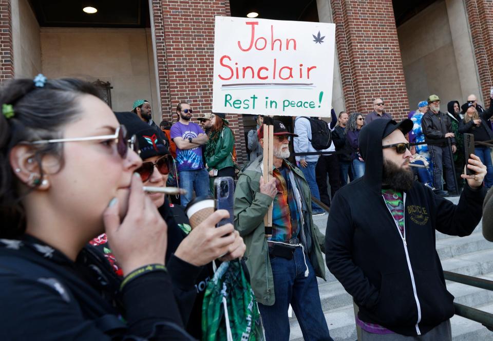 Chuck Ream honors John Sinclair, a longtime marijuana activist who passed away earlier in the week, as various speakers talk to the crowds during the 53rd Ann Arbor Hash Bash at the Diag on the campus of the University of Michigan on Saturday, April 6, 2024.