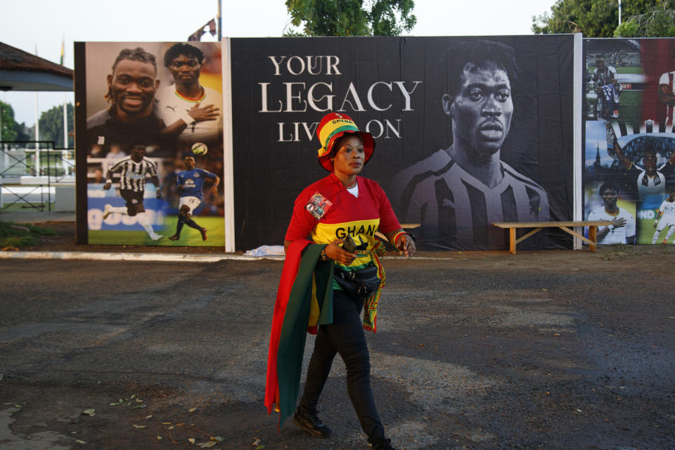 A supporter of Ghana's soccer player Christian Atsu walks by a mural raised in his honour outside the State House during his funeral in Accra, Ghana, Friday, March 17, 2023. Atsu, who played for Premier League teams Chelsea and Newcastle, before joining Turkish club Hatayspor last year, was found dead in his collapsed apartment building in the Turkey earthquake. (AP Photo/Misper Apawu)