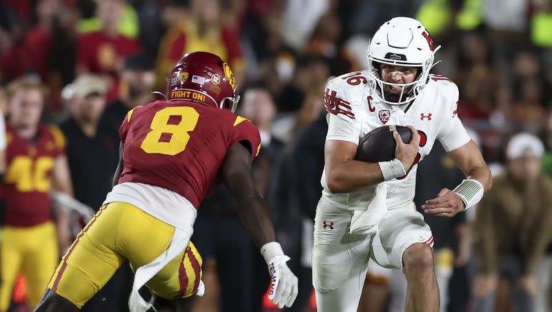 Utah Utes quarterback Bryson Barnes (16) runs past USC Trojans safety Zion Branch (8) as the Utes and the USC Trojans face each other at the Los Angeles Memorial Coliseum on Saturday, Oct. 21, 2023.