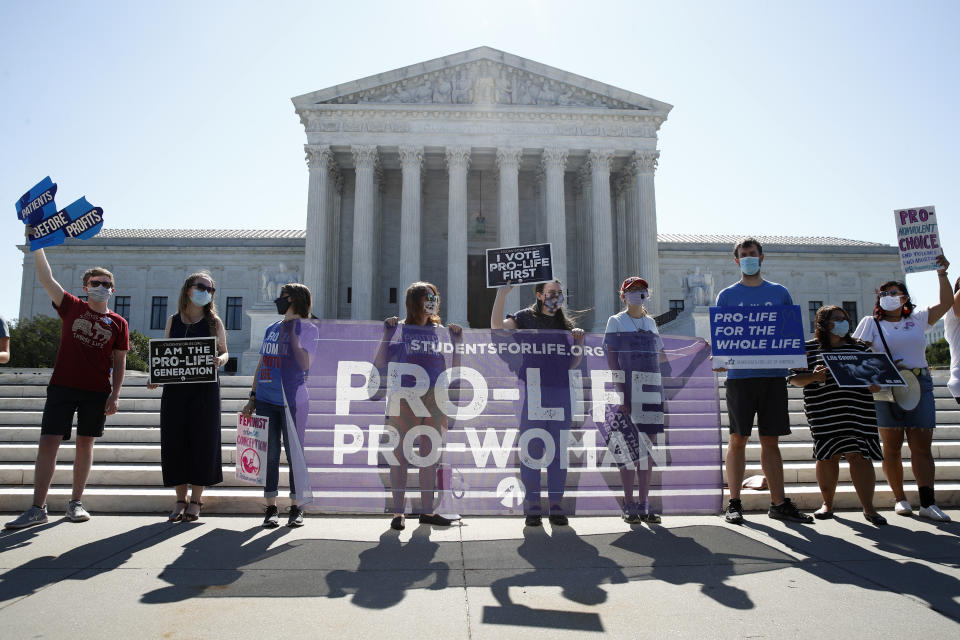 FILE - In this June 29, 2020 file photo, Anti-abortion protesters wait outside the Supreme Court for a decision, in Washington on the Louisiana case, Russo v. June Medical Services LLC. Even before a strict abortion ban took effect in Texas this week, clinics in neighboring states were fielding more and more calls from women desperate for options. he Texas law, allowed to stand in a decision Thursday, Sept. 2, 2021 by the U.S. Supreme Court, bans abortions after a fetal heartbeat can be detected, typically around six weeks. (AP Photo/Patrick Semansky)