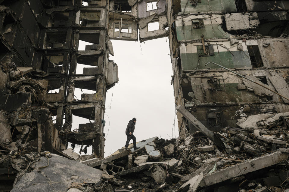 A resident looks for belongings in an apartment building destroyed during fighting between Ukrainian and Russian forces in Borodyanka, Ukraine, Tuesday, April 5, 2022. (AP Photo/Vadim Ghirda)