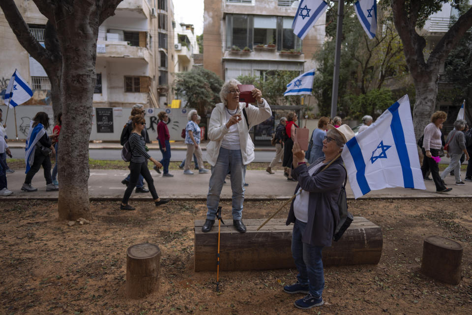 Israeli "grandmothers for democracy" protest plans by Prime Minister Benjamin Netanyahu's government to overhaul the judicial system, saying the planned reform is worrying for the future of the country, in Tel Aviv, Israel, Wednesday, March 22, 2023. (AP Photo/Oded Balilty)