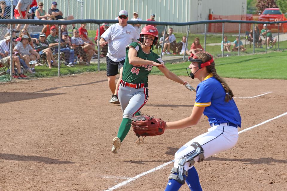 Oak Harbor's Sydney Overmyer looks to slide into home plate.