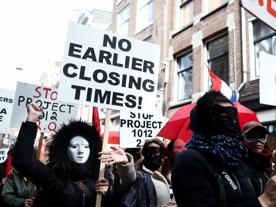 Sex workers and sympathisers take part in a demonstration to protest plans to shutter the city's historic red light district, to be moved to a new erotic centre, in Amsterdam on March 30, 2023. - Amsterdam wants to move legal prostitution outside the city centre's famed red light district over complaints from residents over crime and visitors' behaviour. (Photo by Kenzo TRIBOUILLARD / AFP) (Photo by KENZO TRIBOUILLARD/AFP via Getty Images)