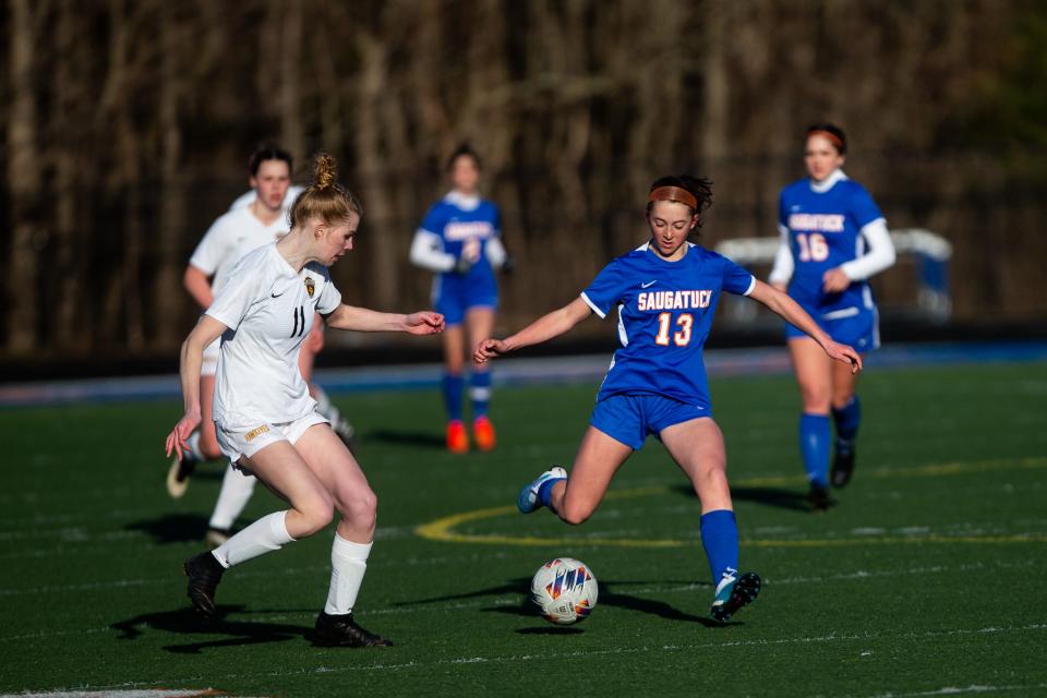 Saugatuck's Neave Rewa steps into her kick as she looks to lob the ball down field against Hamilton Monday, March 27, 2023, at Saugatuck High School. 