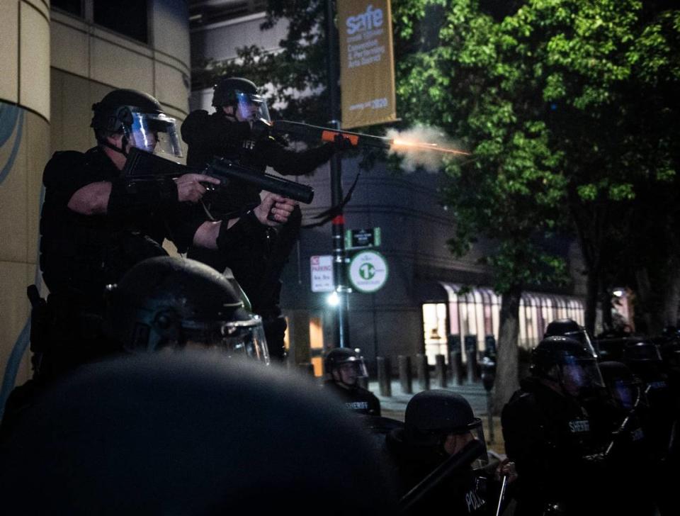 A Sacramento County Sheriff’s deputy shoots a non-lethal projectile during a protest in front of the Main Jail in downtown Sacramento in 2020. The demonstrators were reacting to the death of George Floyd in Minneapolis.