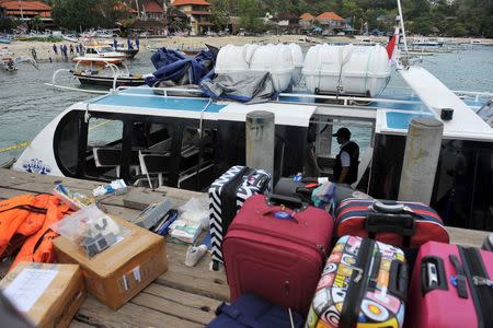 Tourists' luggage is seen on the dock next to a ferry boat which had an explosion while carrying passengers from the island of Bali to Lombok, at Padangbai port, Bali, Indonesia September 15, 2016 in this photo taken by Antara Foto. Antara Foto/Nyoman Budhiana/via REUTERS