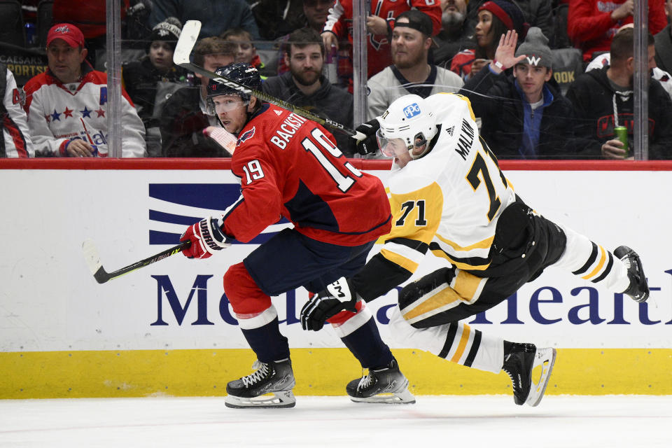 Pittsburgh Penguins center Evgeni Malkin (71) falls to the ice next to Washington Capitals center Nicklas Backstrom (19) during the second period of an NHL hockey game Thursday, Jan. 26, 2023, in Washington. (AP Photo/Nick Wass)