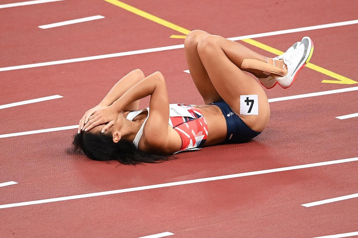 Katarina Johnson-Thompson of Team Great Britain reacts as she lies injured after the Women's Heptathlon 200m heats on day twelve of the Tokyo 2020 Olympic Games at Olympic Stadium on August 04, 2021 in Tokyo, Japan