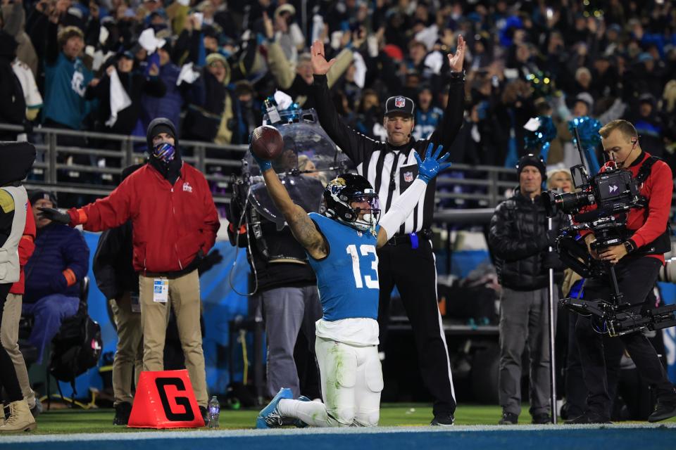 Jacksonville Jaguars wide receiver Christian Kirk (13) reacts to scoring a touchdown during the fourth quarter of an NFL first round playoff football matchup Saturday, Jan. 14, 2023 at TIAA Bank Field in Jacksonville, Fla. Jacksonville Jaguars edged the Los Angeles Chargers on a field goal 31-30. [Corey Perrine/Florida Times-Union]