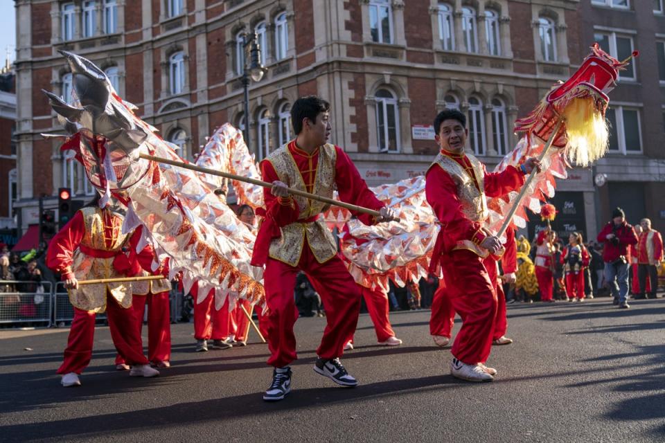 PA-70676803.jpg: Performers taking part in a parade involving costumes, lion dances and floats during Chinese New Year celebrations in Londo (PA)