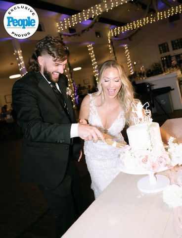 <p>Tiffany Maysonet Photography</p> Jared Kelderman and Kristi Ford cut their wedding cake
