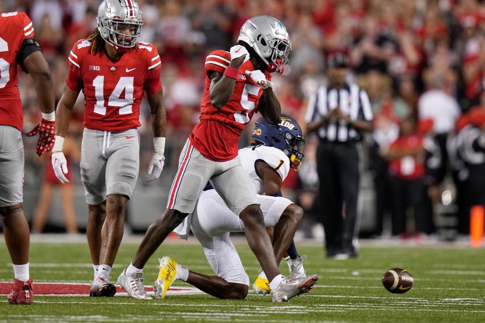 Sep 17, 2022; Columbus, Ohio, USA; Ohio State Buckeyes cornerback Denzel Burke (5) celebrates a stop on a pass attempt to Toledo Rockets wide receiver Jerjuan Newton (1) during the first half of the NCAA Division I football game at Ohio Stadium. Mandatory Credit: Adam Cairns-The Columbus Dispatch