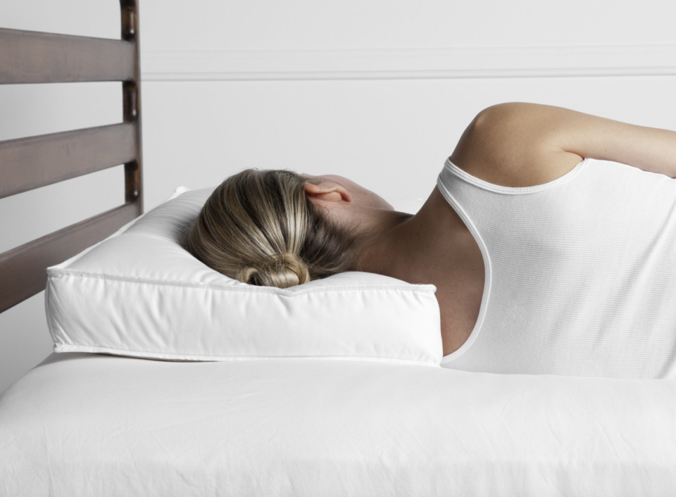 woman with blonde hair laying on bed sleeping, Parachute Down Alternative Side Sleeper Pillow (Photo via Parachute)