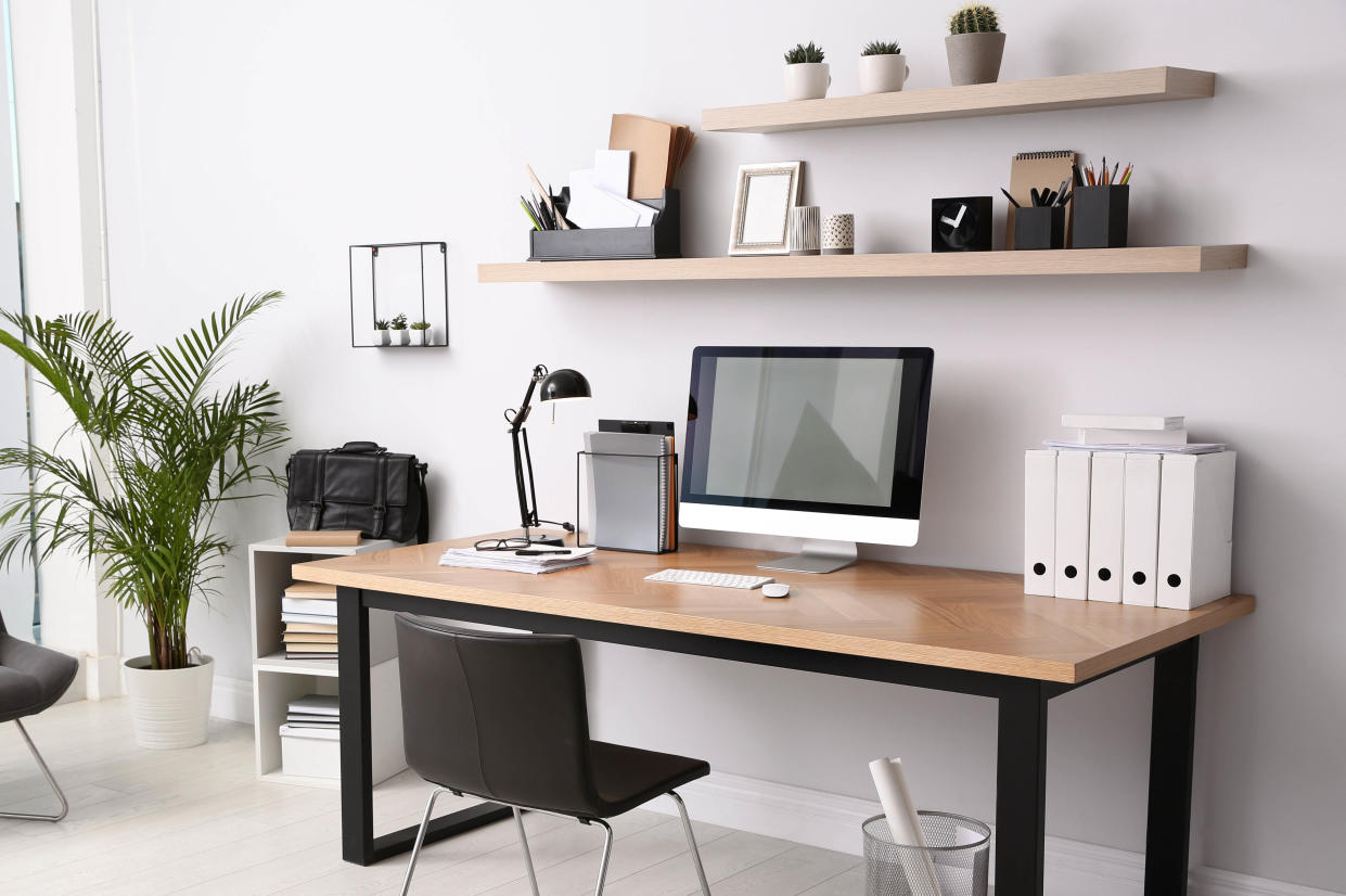  Desk with computer and office supplies in home office. 