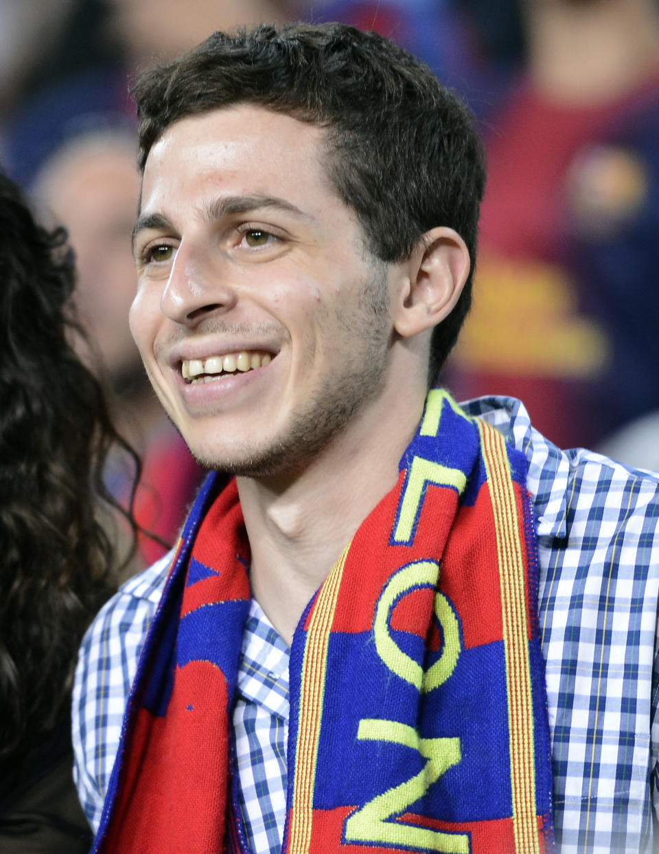 FILE - Israeli soldier Gilad Shalit, right, smiles during a Spanish La Liga soccer match between FC Barcelona and Real Madrid at the Camp Nou stadium in Barcelona, Spain, Oct. 7, 2012. Hamas' 2006 seizure of Shalit consumed Israeli society for years — a national obsession that prompted Israel to heavily bombard the Gaza Strip and ultimately release over 1,000 Palestinian prisoners, many of whom had been convicted of deadly attacks on Israelis, in exchange for Shalit’s freedom. This time, Gaza’s Hamas rulers have abducted dozens of Israeli civilians and soldiers as part of a multipronged, shock attack. (AP Photo/Manu Fernandez, File)