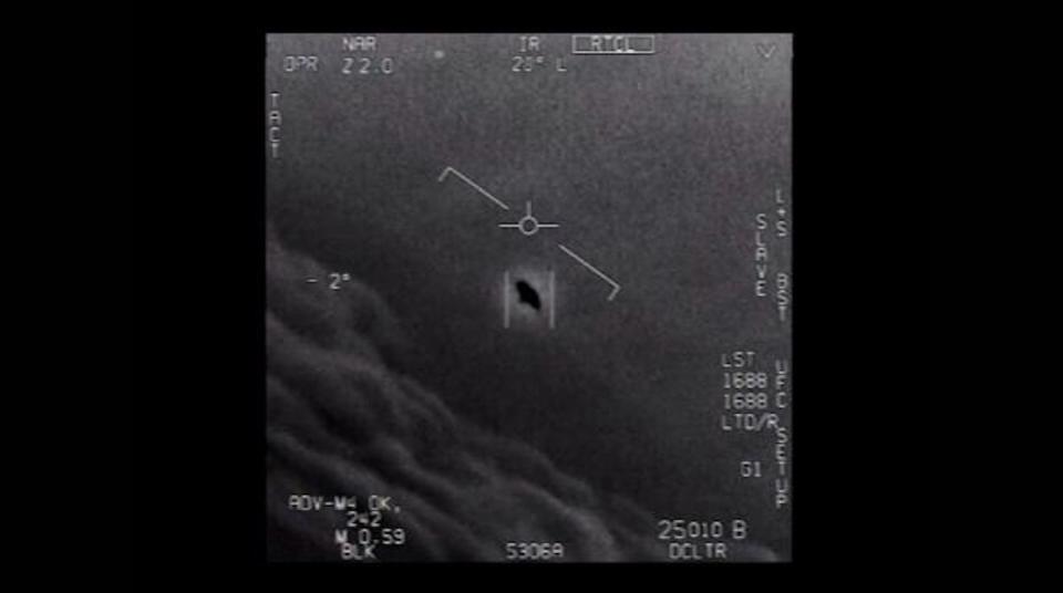 a blurry object in the sky in a black and white image