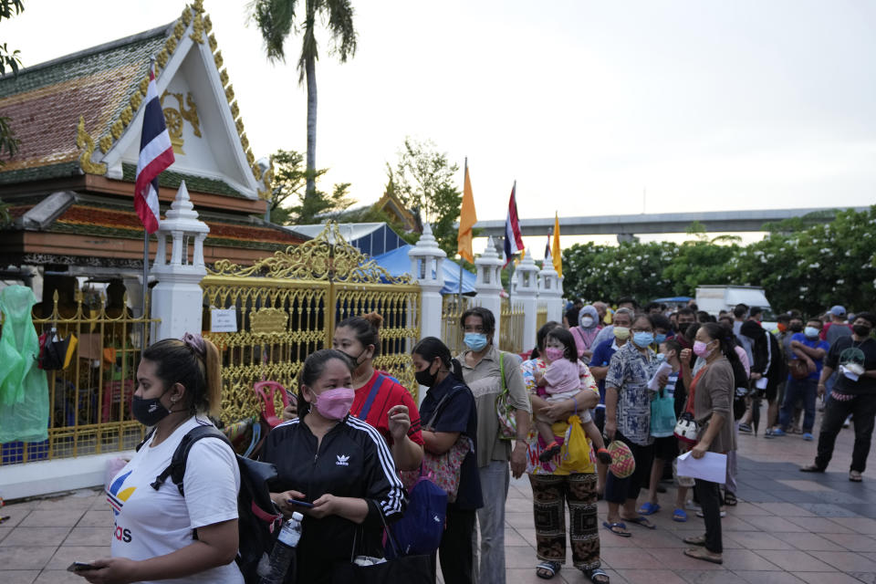 Locals wait in line overnight for free coronavirus testing at the Wat Phra Si Mahathat temple in Bangkok, Thailand, Friday, July 9, 2021. Faced with rapidly rising numbers of new coronavirus infections and growing concern over the proliferation of the highly contagious delta variant, major Asia-Pacific cities implemented new restrictions Friday in the hope of reversing the trend before health care systems are overwhelmed. (AP Photo/Sakchai Lalit)