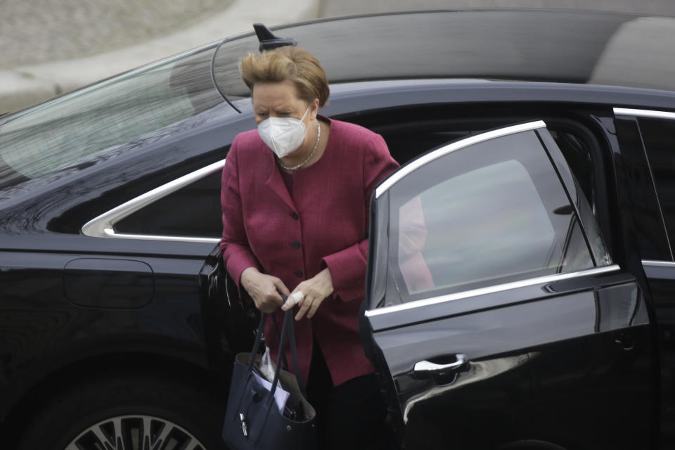 German Chancellor Angela Merkel arrives for a parliament session about a new law to battle the coronavirus pandemic at the parliament Bundestag in Berlin, Germany, Friday, April 16, 2021. (AP Photo/Markus Schreiber)