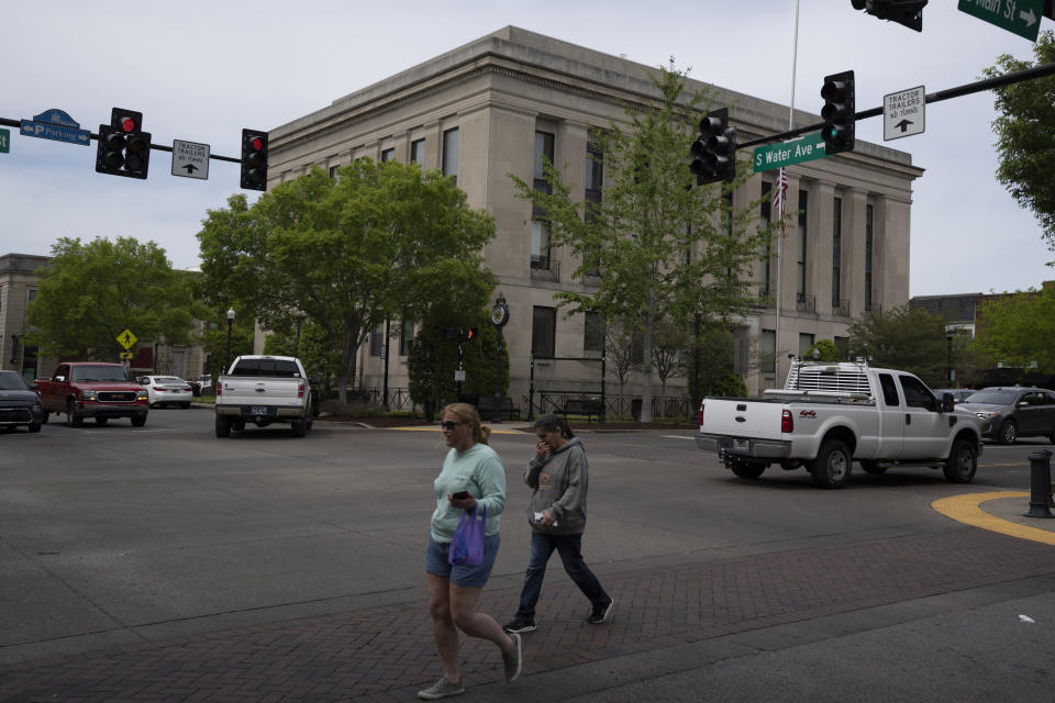 Pedestrians cross South Water Ave. in front of the courthouse Thursday, May 4, 2023, in Gallatin, Tenn. In Sumner County, a local Constitutional Republicans group won a majority last year on the county commission. They have waged a political war on fellow Republicans they view as insufficiently conservative and are feuding with the county’s election commission in ways that could affect preparations for the 2024 presidential election. (AP Photo/George Walker IV)