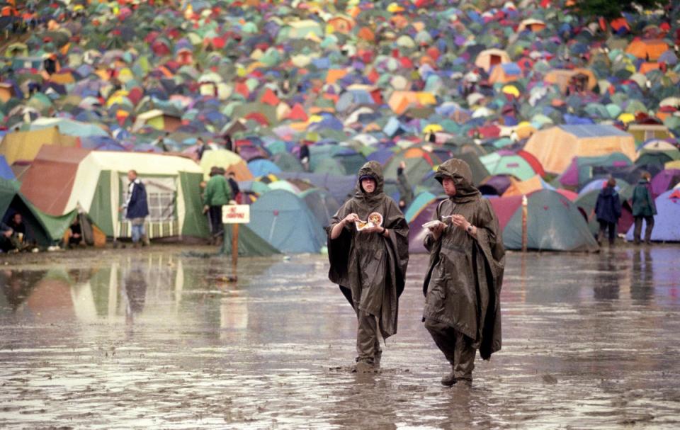 Two festival-goers enjoy a pizza in 1998 (PA)