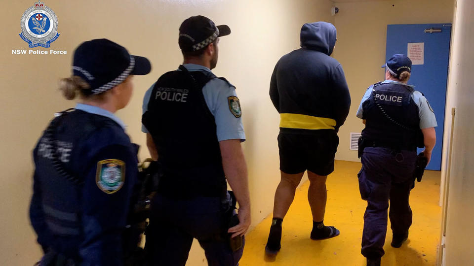 Police, pictured here taking a man into custody over the alleged kidnapping of Stuart MacGill. 