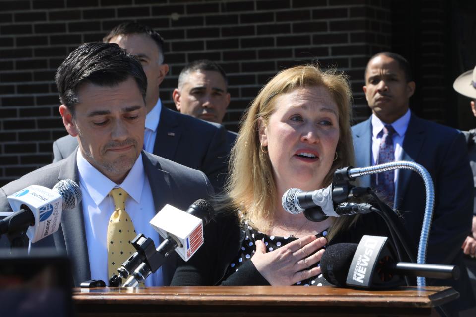 Karen Whalen, sister of Megan McDonald speaks beside her husband, James, at a press conference announcing the arrest of Edward Holley on April 20, 2023.