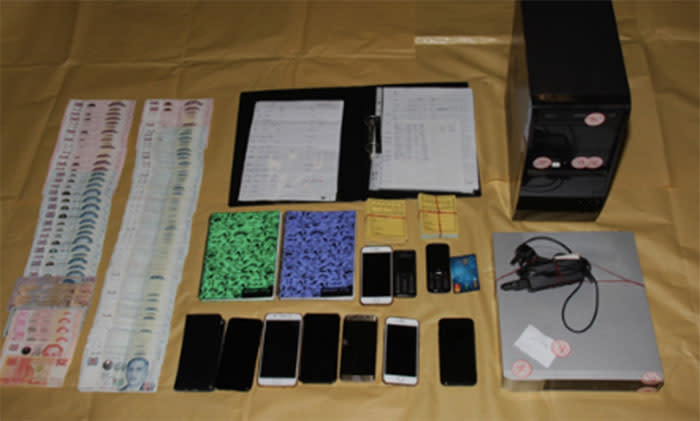 Items linked to illegal moneylending activities by an organised criminal group have been seized by the Police. Photo: Singapore Police Force