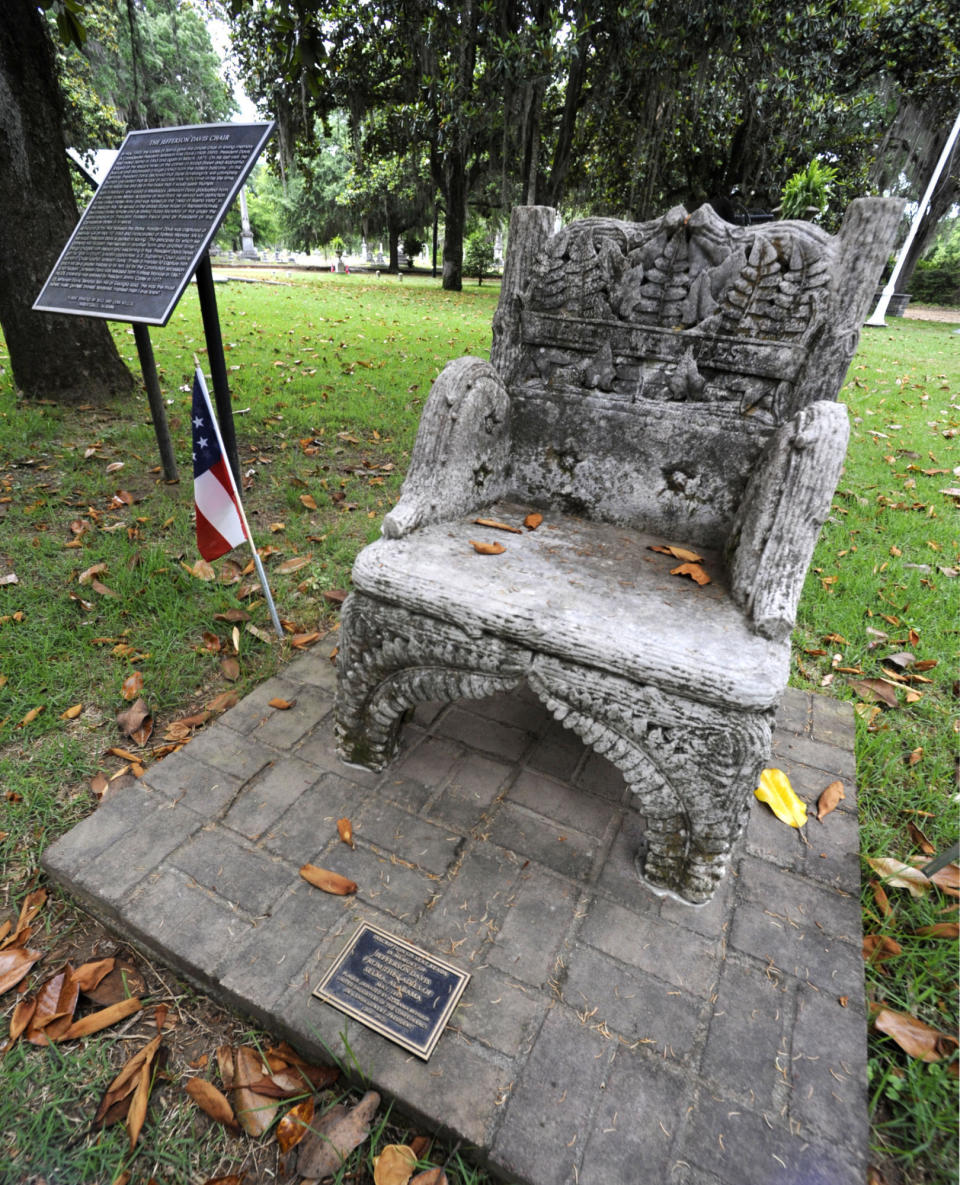 A monument to Confederate President Jefferson Davis, that was previously stolen, is shown back at its regular site at a cemetery in Selma, Ala., on Wednesday, June 2, 2021. Three people were charged following the disappearance of the chair, which was recovered in New Orleans and is now glued down. (AP Photo/Jay Reeves)