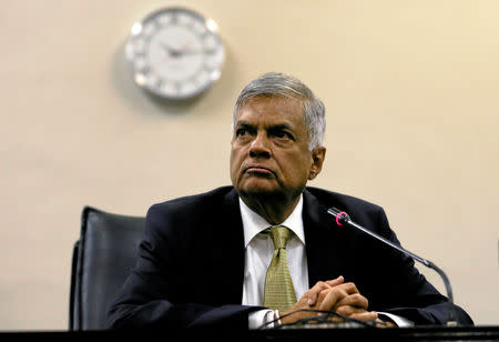 FILE PHOTO: Sri Lankan Prime Minister Ranil Wickremesinghe (C) looks on at a news conference after he survived a no confidence vote in parliament in Colombo, Sri Lanka April 4, 2018. REUTERS/ Dinuka Liyanawatte/File Photo