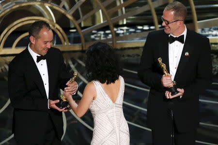 Pete Docter (R) and Jonas Rivera receive the Oscar for Best Animated Feature for "Inside Out" at the 88th Academy Awards in Hollywood, California February 28, 2016. REUTERS/Mario Anzuoni