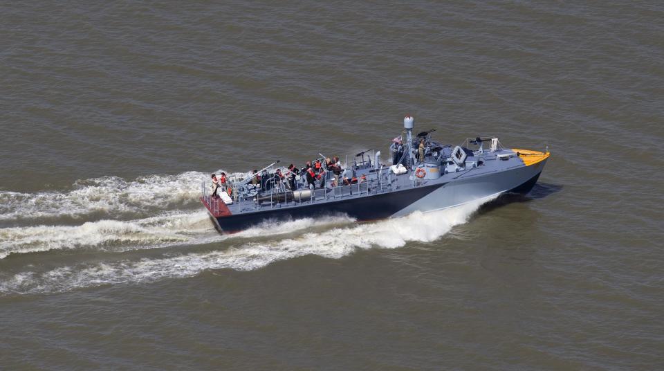 The PT 305, which was restored by the National WWII Museum, cruises with guests of the museum Thursday, March 16, 2017, on Lake Pontchartrain, where she was originally tested by Higgins Industries more than 70 years ago, in New Orleans. The U.S. Navy PT boat that sank three vessels and saw action in Europe in World War II is back in New Orleans where it was built, what historians describe as the nation's only fully restored combat ship of that type from the era. Its return to water is the culmination of a 10-year restoration project by the museum. (AP Photo/Gerald Herbert)