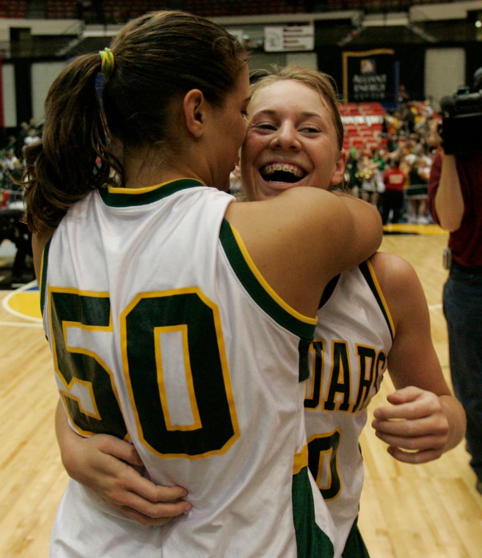 Ashwabenon's Brittany Noskowiak (50) gives a bear hug to Kaitlyn Bettiga after her steal and layup gave Ashwaubenon a 37-35 state-title victory over Waterford.